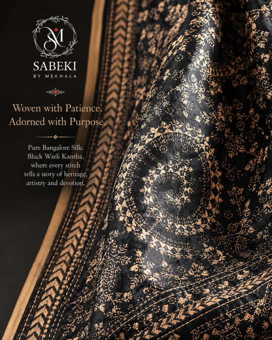 Close-up of hand-stitched Warli embroidery on black silk at Sabeki By Mekhala USA